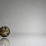 a close up of a coin on a reflective surface